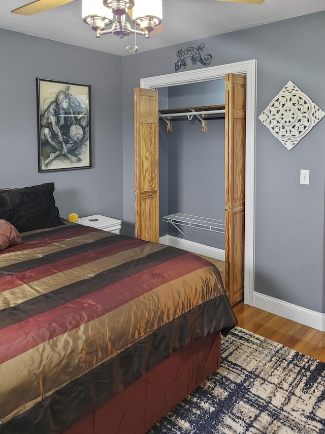 bedroom featuring a chandelier, hardwood / wood-style floors, and a closet