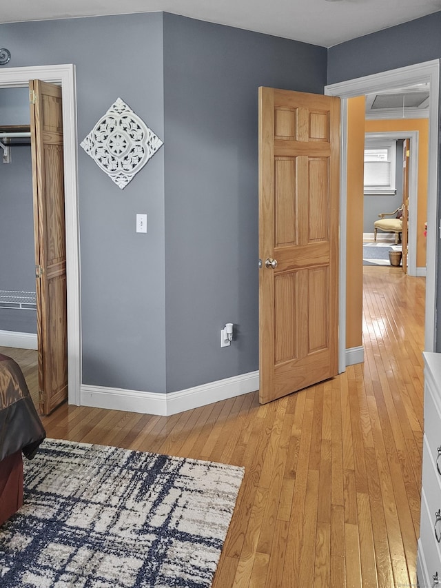 unfurnished bedroom with light hardwood / wood-style flooring and a closet