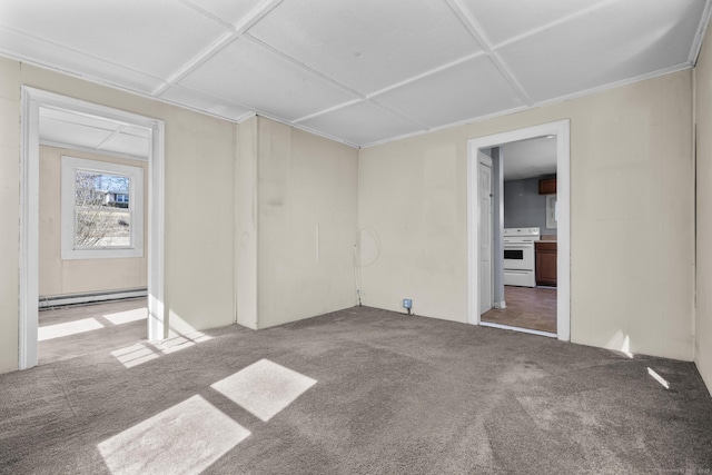 unfurnished room featuring a baseboard heating unit and carpet floors