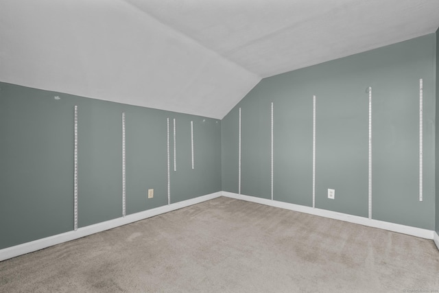 bonus room featuring vaulted ceiling and carpet flooring