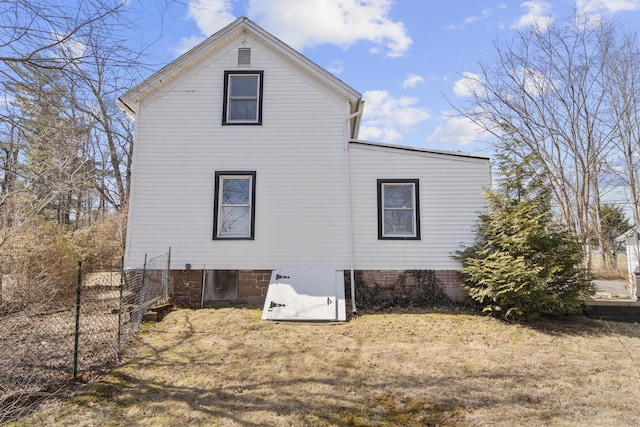 rear view of property featuring fence