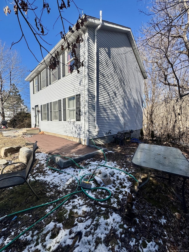 view of snowy exterior with a patio area