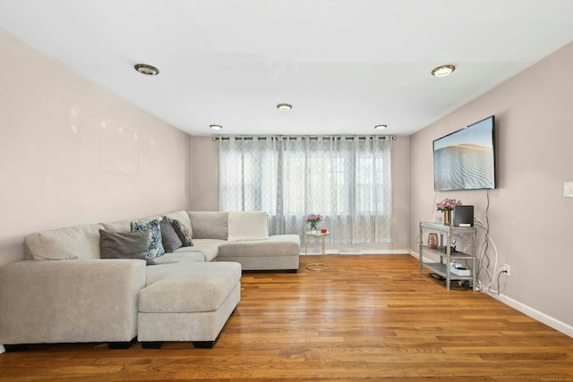 living room featuring wood finished floors and baseboards