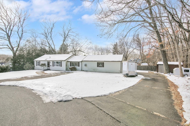 single story home featuring a storage unit