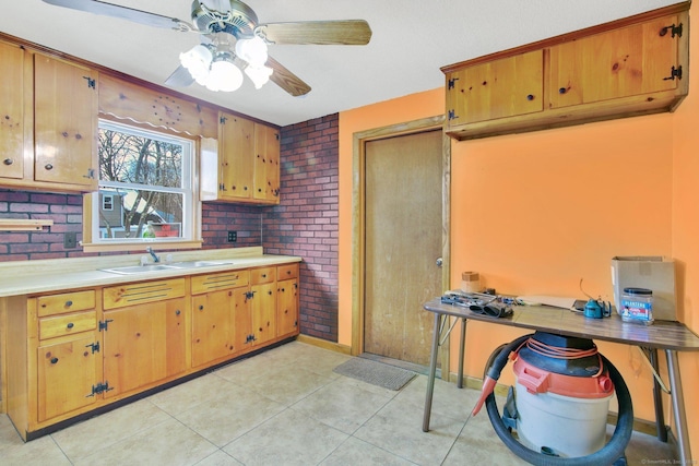 kitchen featuring sink, light tile patterned flooring, and ceiling fan