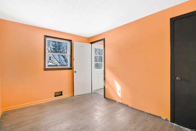 empty room featuring wood-type flooring