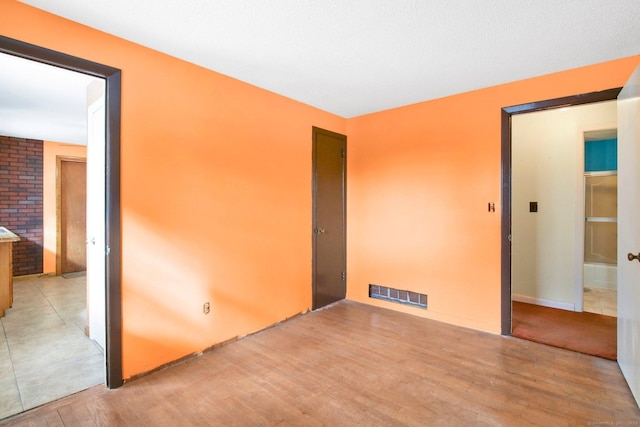 spare room featuring light wood-type flooring