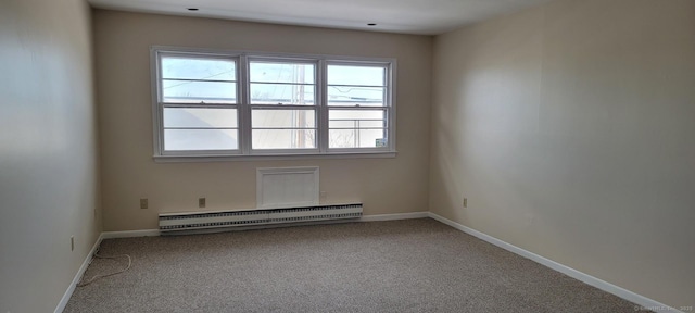 carpeted empty room featuring a baseboard radiator