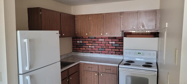 kitchen featuring white appliances and sink