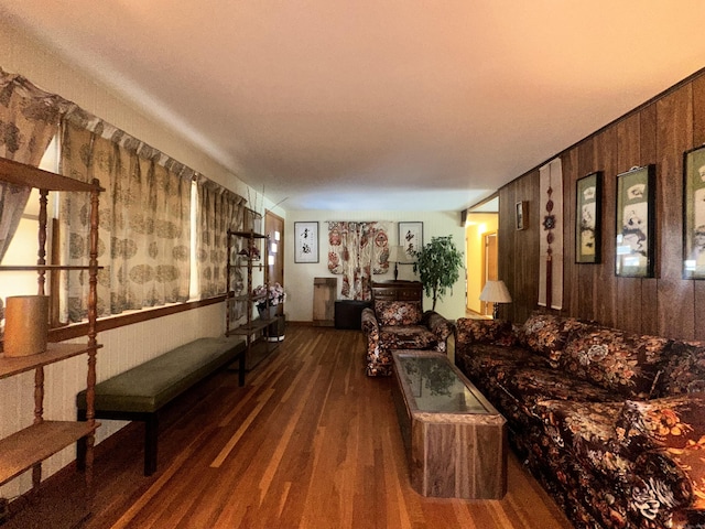 living room featuring dark hardwood / wood-style floors and wood walls