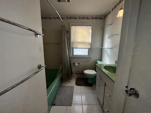 full bathroom featuring tile patterned flooring, vanity, toilet, and shower / bath combo with shower curtain