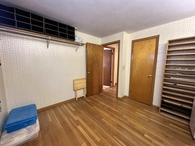 unfurnished bedroom with dark wood-type flooring