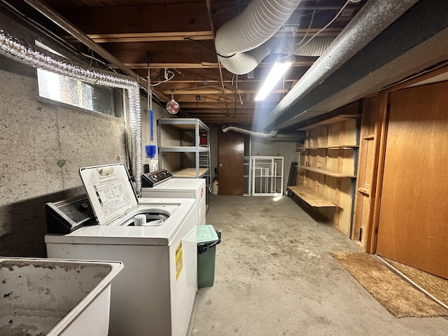 basement featuring washer and clothes dryer and sink