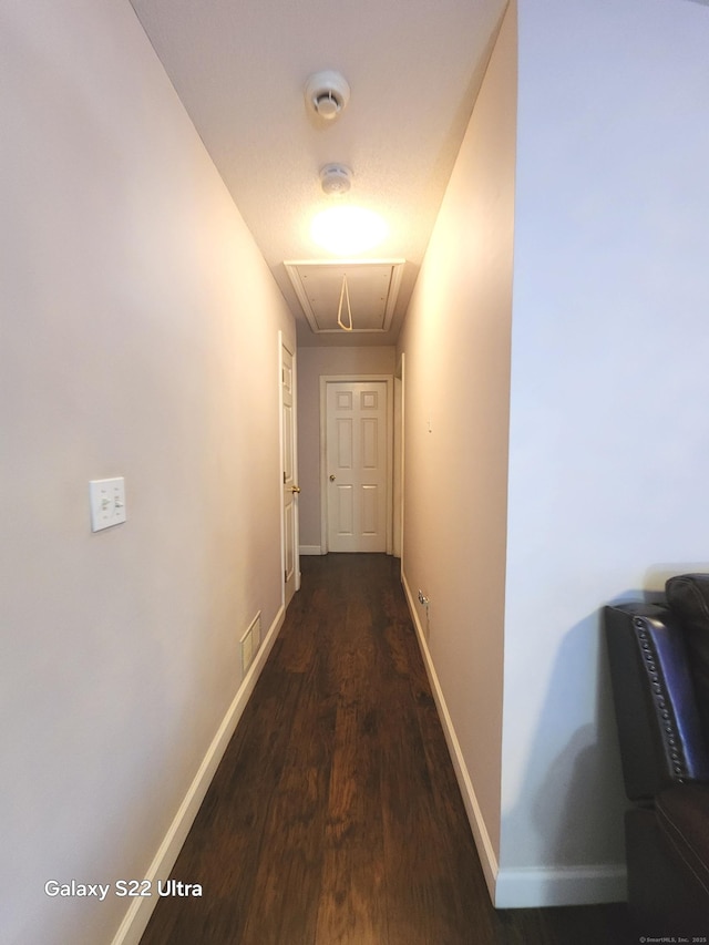 corridor featuring dark hardwood / wood-style floors