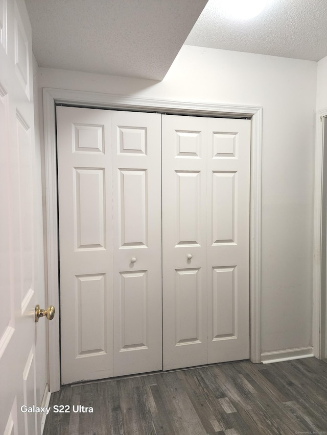 room details featuring wood-type flooring and a textured ceiling