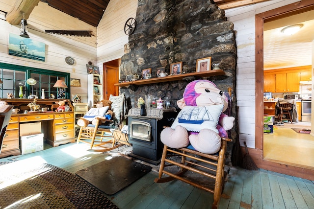108 Fall Mountain Rd, Bristol, CT 06010 - miscellaneous room featuring wood walls, a wood stove, hardwood / wood-style flooring, and high vaulted ceiling