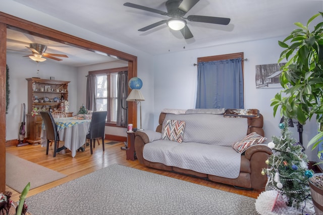 living room with light hardwood / wood-style flooring and ceiling fan