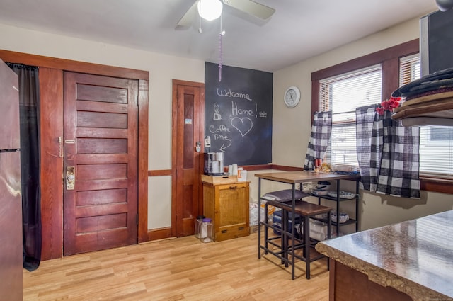 dining area with ceiling fan and light hardwood / wood-style floors