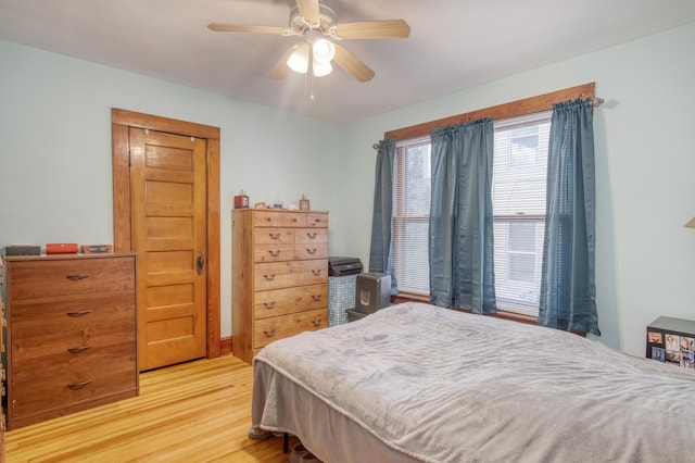 bedroom with ceiling fan and light hardwood / wood-style floors