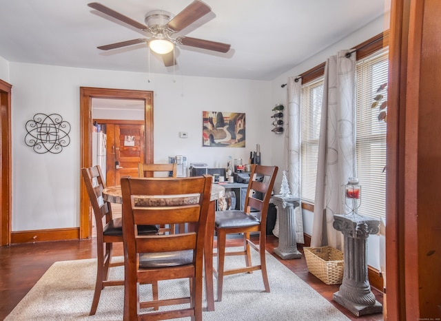 dining space featuring ceiling fan and dark hardwood / wood-style flooring