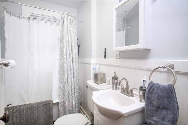 full bathroom with vanity, shower / bathtub combination with curtain, and toilet