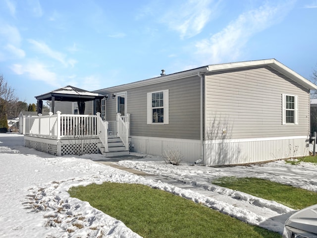 manufactured / mobile home featuring a gazebo and a deck