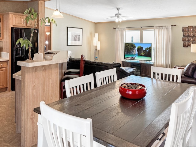 dining room featuring light tile patterned flooring, crown molding, and ceiling fan