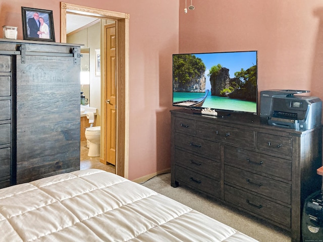 carpeted bedroom featuring connected bathroom