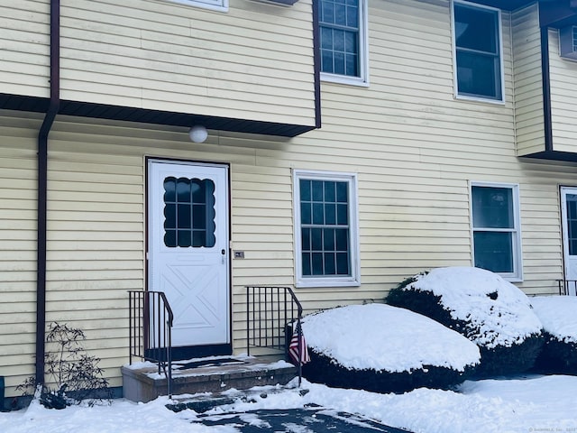 view of snow covered property entrance