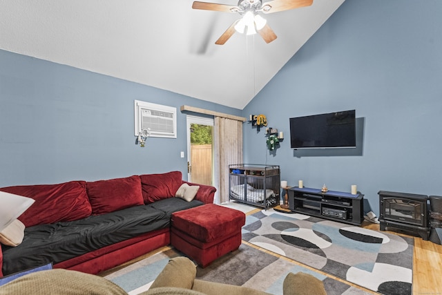 living room with wood-type flooring, high vaulted ceiling, an AC wall unit, a wood stove, and ceiling fan