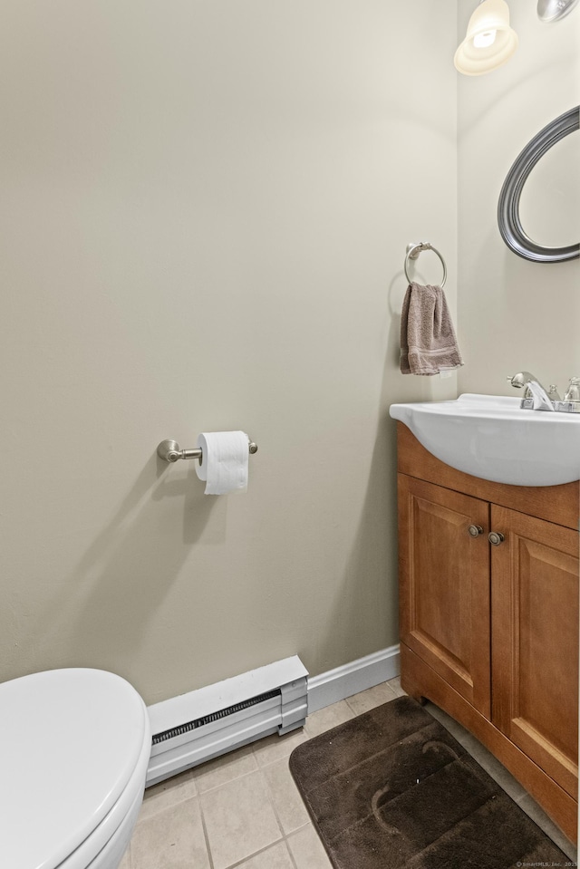 bathroom with baseboard heating, tile patterned floors, toilet, and vanity