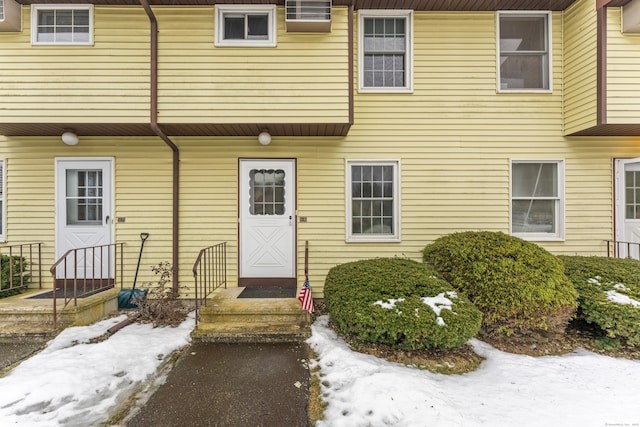 view of snow covered property entrance