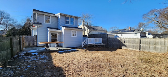 back of property with a wooden deck