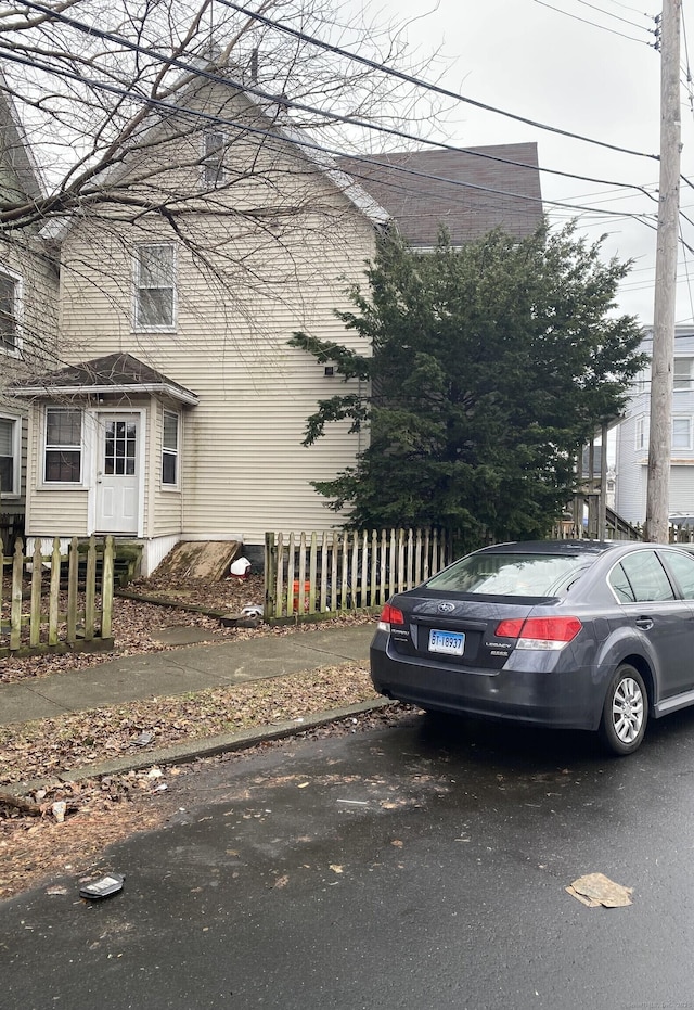 view of front of house featuring fence