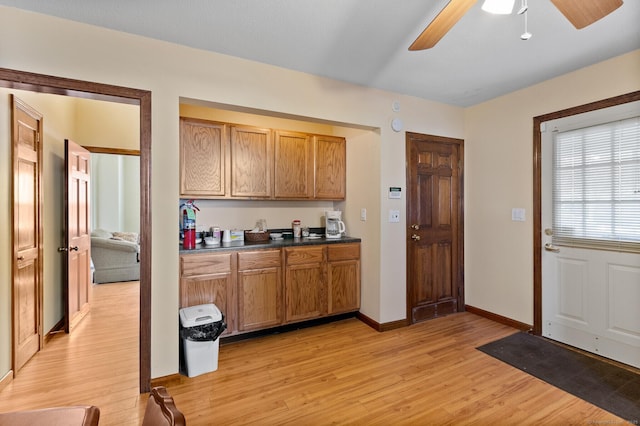 kitchen with ceiling fan and light hardwood / wood-style floors