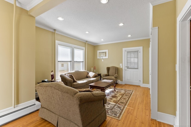 living room featuring hardwood / wood-style flooring, a baseboard radiator, and ornamental molding