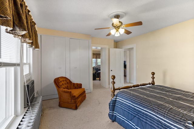 bedroom with ceiling fan and a closet