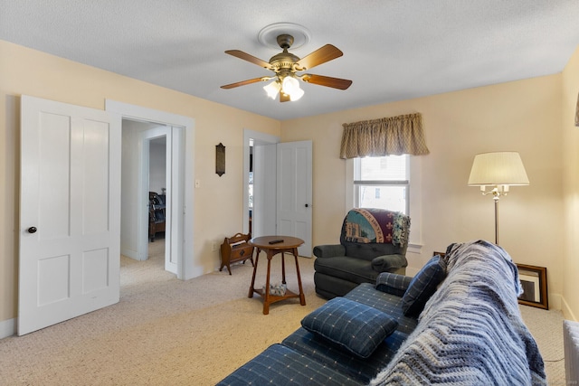 carpeted living room with ceiling fan