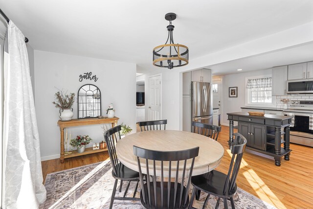 dining room featuring an inviting chandelier and light hardwood / wood-style flooring