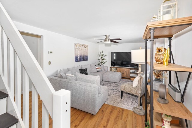 living room featuring ceiling fan and light wood-type flooring