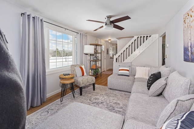 living room with ceiling fan and light hardwood / wood-style flooring