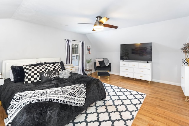 bedroom with lofted ceiling, hardwood / wood-style floors, and ceiling fan