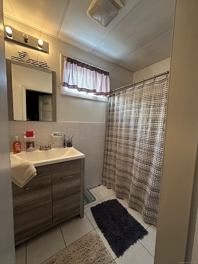 bathroom featuring tile walls, vanity, tile patterned flooring, and curtained shower