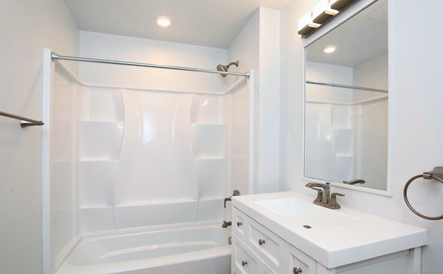 bathroom featuring vanity and  shower combination