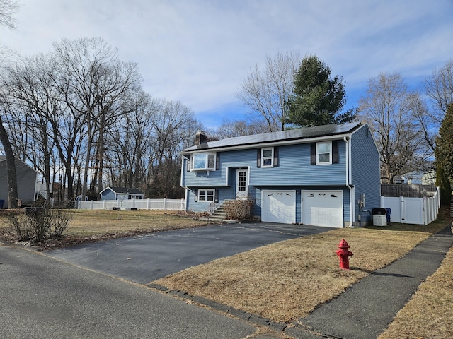 raised ranch with a garage and central AC