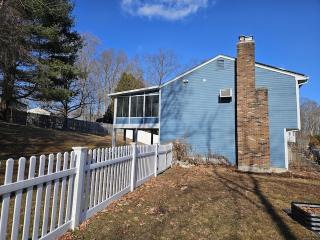 view of side of home with a sunroom