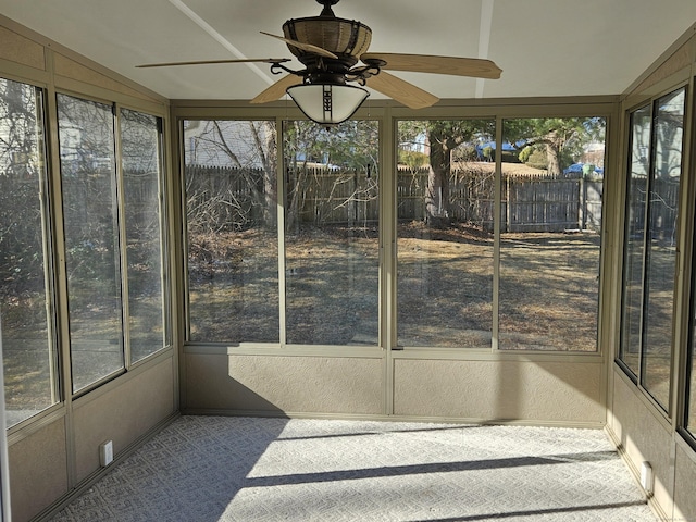 sunroom / solarium with ceiling fan and vaulted ceiling