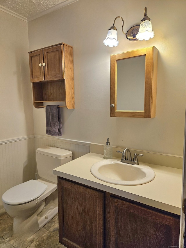 bathroom featuring vanity, a textured ceiling, and toilet