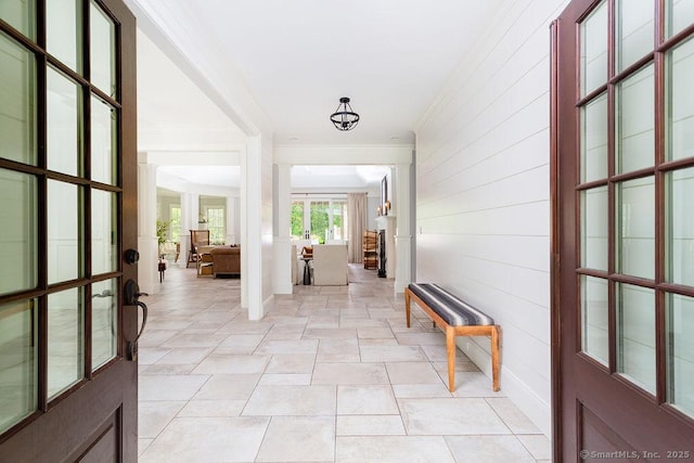 interior space featuring crown molding and ornate columns