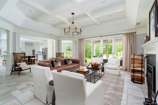 living room with coffered ceiling, beam ceiling, a chandelier, and ornate columns